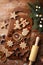 Christmas gingerbread cookies and fir tree on wooden kitchen board top view. Homemade sweet pastries for winter holidays