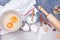 Christmas gingerbread cookies with whisk, eggs, dough and rolling pin.