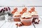 Christmas gingerbread cupcakes against a rustic white wood background