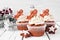 Christmas gingerbread cupcakes against a rustic white wood background