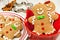 Christmas gingerbread men cookies in red bowl on white wood
