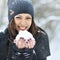 Christmas girl outdoor portrait. Winter woman blowing snow in a