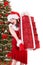 Christmas girl in santa holding stack gift box.