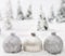 Christmas glass balls in winter miniature forest scenery with snow.