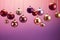 Christmas glass baubles elegantly hang against a gradient of burgundy, purple, & lavender background, blending festive charm with