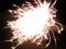 Christmas glittering sparkler. Burning Holiday Party Sparkler in night