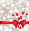 Christmas glowing background with gift bow and sweet canes