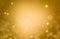 Christmas glowing Golden Background. Christmas lights. Gold Holiday New year Abstract Glitter Defocused Background With Blinking