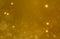 Christmas glowing Golden Background. Christmas lights. Gold Holiday New year Abstract Glitter Defocused Background With Blinking