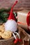 A Christmas gnome in a red hat close-up sits in a plate with homemade cookies