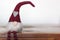 Christmas gnome sitting on wooden table with copy space