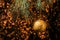 Christmas gold ball hanging on pine branches with festive orange background