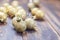 Christmas golden glittered balls on brown wooden background.