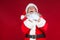 Christmas. Good Santa Claus in white gloves shows faces, grimaces, shows his tongue. Not standard behavior. on