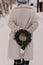 Christmas green wreath in hands. White artificial fur. Zero waste. Snowy winter day. Having fun. So much snow. Village life.