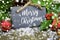 Christmas greeting card with german words for merry christmas - frohe weihnachten with christmas decorations on small slate chalk