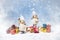 Christmas greeting card. Noel gnomes, small gifts, snow texture. Christmas symbol.
