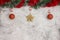 Christmas grey background with big red baubles and gold star. Red and green tinsel top. Space for text