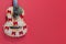 Christmas guitar on a red background with snowflakes and red bows. An invitation to a New Year's musical concert. Winter