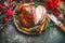 Christmas ham served with roasted vegetables and festive decorations on vintage background in retro color, top view, place for tex