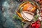 Christmas ham served with roasted vegetables and festive decorations on vintage background, top view, place for text. Christmas re