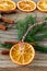 Christmas handmade natural decorations. Garland and fir tree toy made of dried slices of oranges on wooden table. Winter still