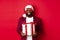 Christmas. Handsome african american man in party glasses and santa hat holding new year gift, bring present in box and