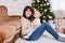 Christmas, happiness and family concept - portrait of happy mother and little daughter near decorated christmas tree