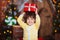 Christmas happiness. Happy little smiling girl holding Christmas gift box