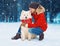 Christmas happy young woman owner petting embracing white Samoyed dog on snow in winter over snowflakes