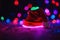 Christmas hat on the floor with bright lights around, xmas wallpaper