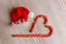 Christmas hat and Lollipop cane in the form of a sleigh and a heart on a wooden background