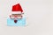 Christmas hat of santa claus with glasses protective mask on light gray background. Copy space