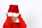 Christmas helper child put on Santas Claus hat on head front of white background