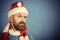 Christmas hipster with beard and moustache on frown face