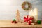 Christmas holiday background with gift box, ornaments and candle decor on wooden table. Winter greeting card