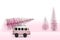 Christmas holiday concept with pine tree on toy car, pink Christmas tree on a retro minibus driven home from the forest. Copy