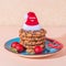 Christmas holiday cookies homemade sweet dessert on a blue plate and attributes New Year symbols on a peach color background