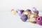 Christmas holiday festive theme with golden pink violet ball LED garland and gold and purple Christmas ornament