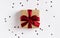 Christmas holiday gift box red bow on decorated festive table with sparkle stars