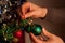 Christmas holiday green and red decoration. Guy& x27;s hands ornament