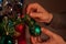 Christmas holiday green and red decoration. Guy& x27;s hands ornament