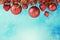 Christmas holiday ornaments hanging over blue bokeh background with copy space