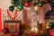 Christmas holiday red, green, yellow and silver decoration hanging from a pine tree with a treasure box and present box and