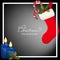Christmas holiday season background with Christmas candle with fire, Red socks with candy canes and Holly Berries.