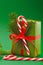 Christmas holiday wrapped gift box on green background