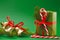 Christmas holiday wrapped gift box on green background