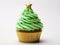 Christmas homemade cupcake as Xmas tree with green whipped cream and golden star on white background