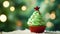 Christmas homemade cupcake as Xmas tree with green whipped cream and red star on green bokeh background, Space for text