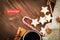 Christmas hot steaming cup of glint wine with spices, anise, cookies in a shape of star, red candies, pepper and gray scarf on